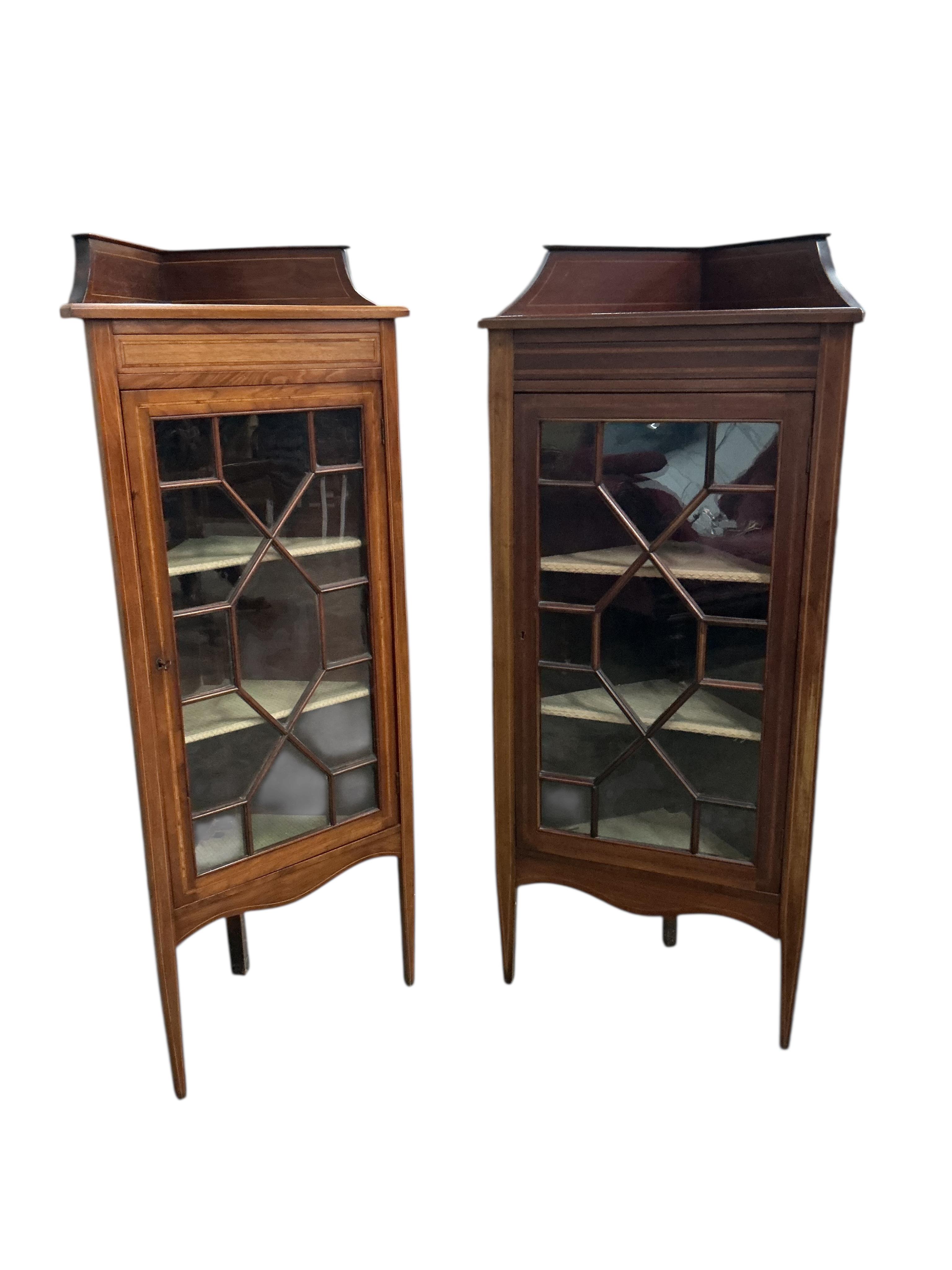 A pair of Edwardian mahogany standing corner cabinets, width 54cm, depth 33cm, height 132cm